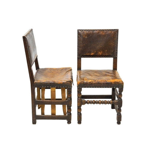 986 - A set of four Cromwellian style oak and leather upholstered dining chairs. .