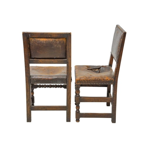 986 - A set of four Cromwellian style oak and leather upholstered dining chairs. .