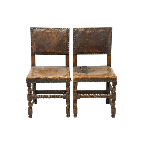 986 - A set of four Cromwellian style oak and leather upholstered dining chairs. .