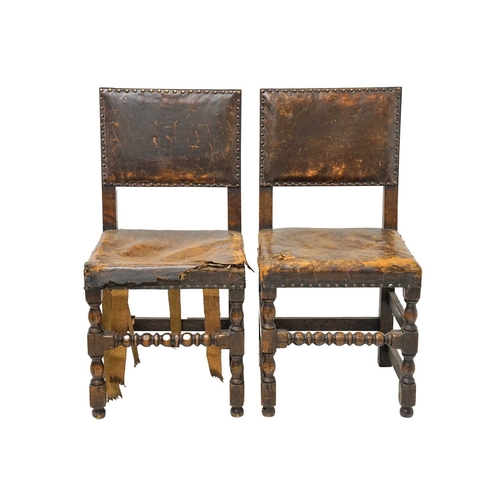 986 - A set of four Cromwellian style oak and leather upholstered dining chairs. .