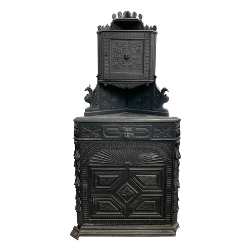 992 - A Victorian carved oak standing corner cupboard. Fitted a small upper cupboard, the single drawer wi... 