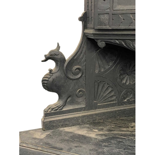 992 - A Victorian carved oak standing corner cupboard. Fitted a small upper cupboard, the single drawer wi... 