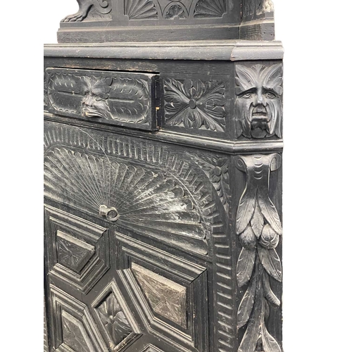 992 - A Victorian carved oak standing corner cupboard. Fitted a small upper cupboard, the single drawer wi... 