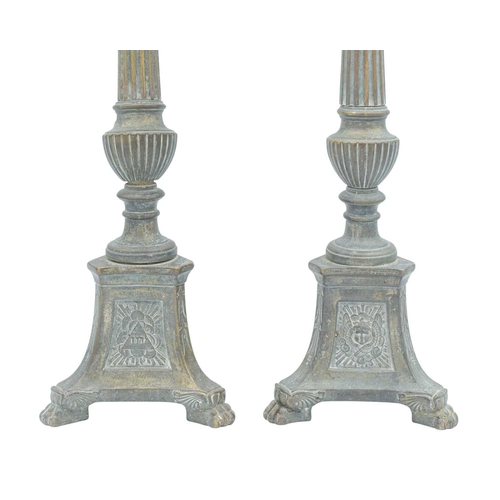 103 - A pair of ecclesiastical brass candlesticks. With fluted column shafts, trefoil bases with repousse ... 