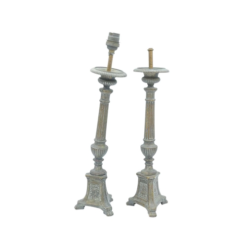 103 - A pair of ecclesiastical brass candlesticks. With fluted column shafts, trefoil bases with repousse ... 