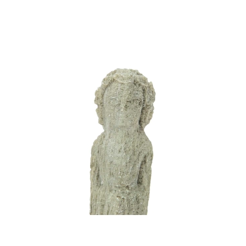 106 - A small carved stone figure of a deity. Possibly limestone, height 15cm.
