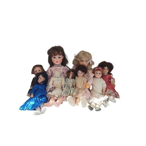 224 - A collection of early 20th century dolls. Comprising an Armand Marseille doll, with bisque head, bru... 