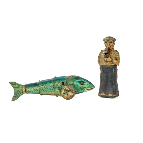 248 - A Clockwork tinplate sailor figure. Fashioned holding a pipe, height 15cm, together with a tinplate ... 