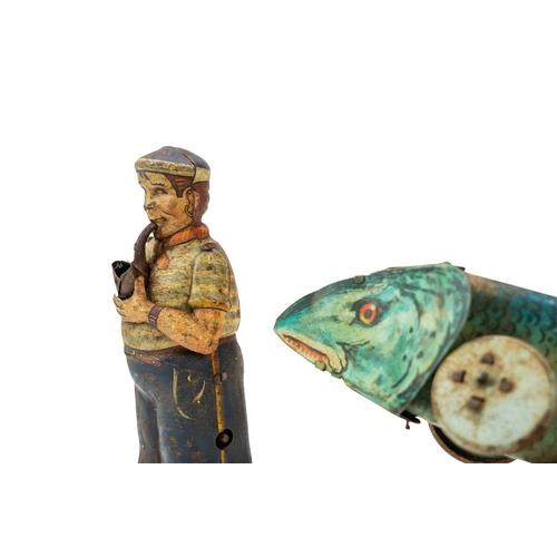 248 - A Clockwork tinplate sailor figure. Fashioned holding a pipe, height 15cm, together with a tinplate ... 