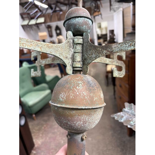 26 - A copper weathervane. modelled as a hollow fox above the compass points, length 82cm. Ex Gwel An Mor... 