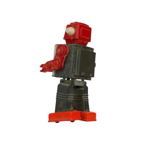 266 - A Japanese tinplate and plastic gear robot. Some rust and grime, not seen working, height 23cm.