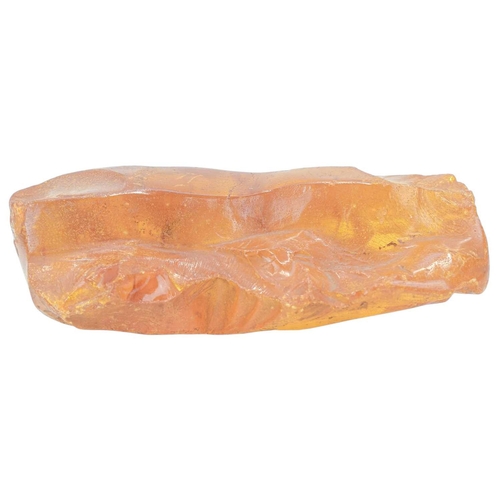 28 - An unworked amber boulder. Height 6cm, width 18cm, depth 12cm, 585g.