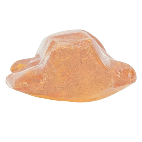 28 - An unworked amber boulder. Height 6cm, width 18cm, depth 12cm, 585g.