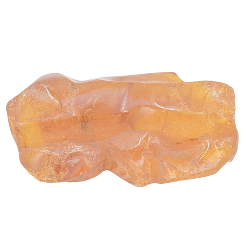 28 - An unworked amber boulder. Height 6cm, width 18cm, depth 12cm, 585g.