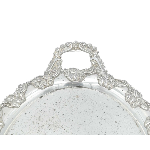 297 - A modern silver coaster. Diameter 12.5cm, with a presentation inscription, together with a silver pl... 