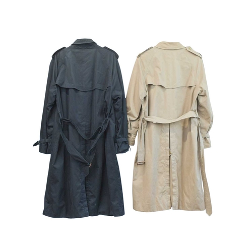 324 - Two Burberry trench coats. One black, one tan, both with a chest measurement of approximately 21
