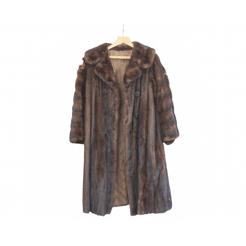 324 - Two Burberry trench coats. One black, one tan, both with a chest measurement of approximately 21
