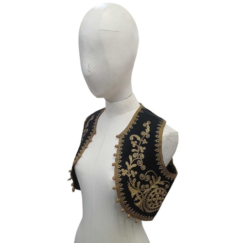 335 - An Ottoman embroidered child's waistcoat. Black felt with golden thread embroidered details handstit... 