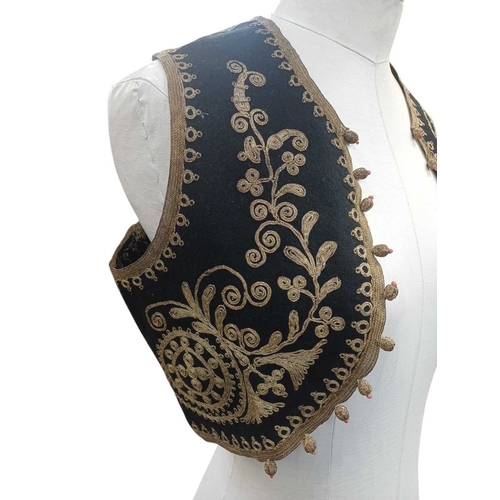 335 - An Ottoman embroidered child's waistcoat. Black felt with golden thread embroidered details handstit... 