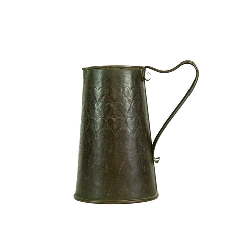 38 - An Arts and Crafts copper ale jug with repousse heart decoration. Height 21.5cm. Together with a J &... 