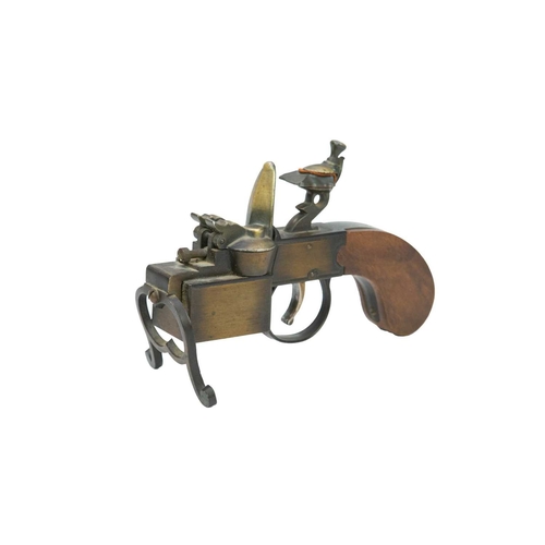 4 - A Dunhill 'Tinder Pistol' table lighter. Formed of wood and brass, the underside marked 'Made in Eng... 