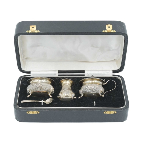 440 - An Indian Sterling silver three piece cruet set. Chased and embossed with elephants in landscapes, s... 