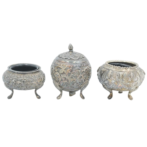 440 - An Indian Sterling silver three piece cruet set. Chased and embossed with elephants in landscapes, s... 