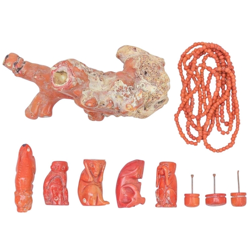 59 - A collection of coral. A beaded coral necklace, length 76cm, three coral snuff bottles carved as mon... 