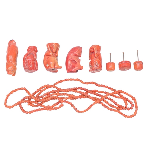 59 - A collection of coral. A beaded coral necklace, length 76cm, three coral snuff bottles carved as mon... 