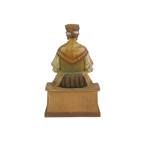 72 - A carved and painted pine figure of a lady knitting. 20th century, probably Flemish, height 19cm.