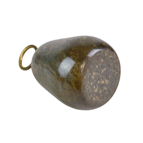 74 - A Cornish serpentine door stop with brass loop handle. Height 18cm.
