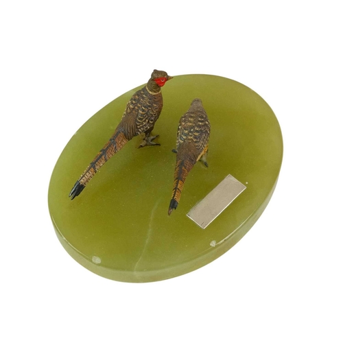 96 - A pair of Austrian cold painted bronze pheasants. Cast as a hen and a cock, on an oval onyx base, wi... 