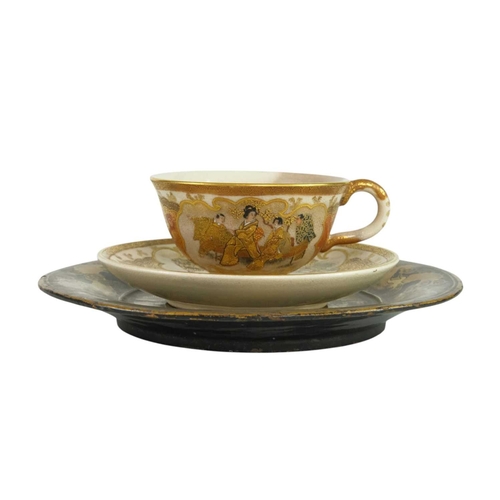 322 - A fine quality Japanese Satsuma small cup and saucer. Painted and gilt with figures in gardens, char... 