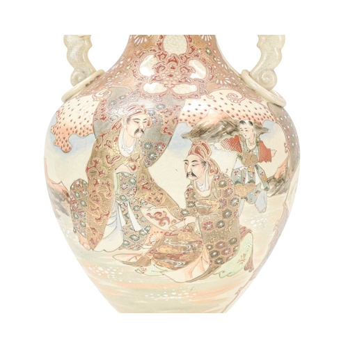 357 - A Japanese Satsuma pottery vase. Circa 1900, with dragon and ring moulded handles, painted with figu... 
