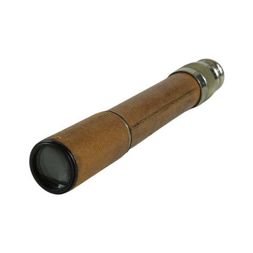 202 - An 'Orion Spotter' two draw telescope. With leather covered outer tube and lens covers, engraved 'Pr... 