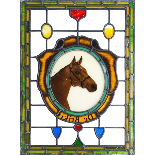 205 - A leaded and stained glass rectangular panel. 20th century, the central oval painted with a horse's ... 