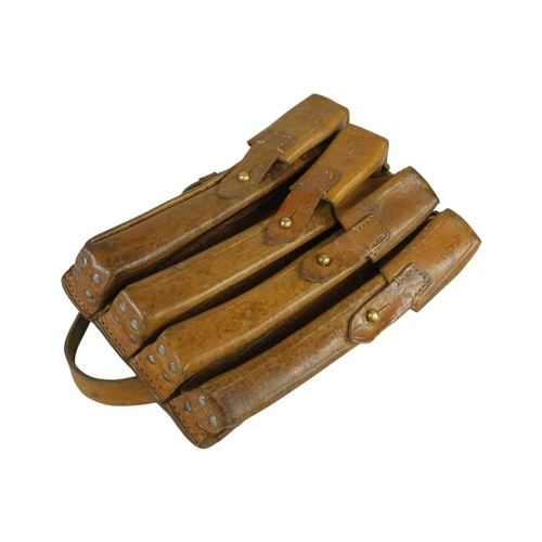 216 - A military leather four pouch magazine holder. With leather strap