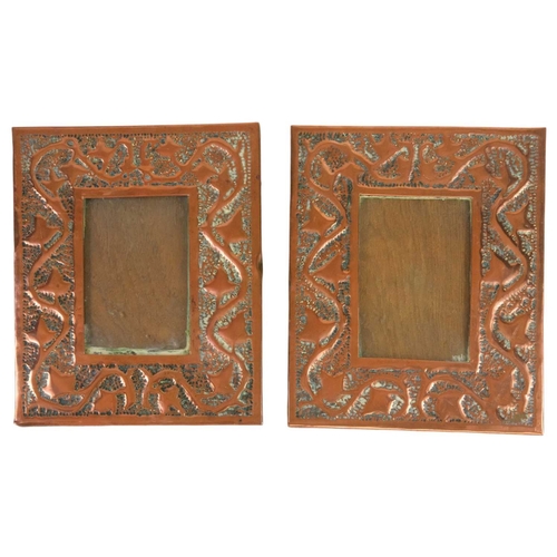 221 - A pair of Arts and Crafts copper photograph frames. Repousse decorated with trailing ivy foliage on ... 
