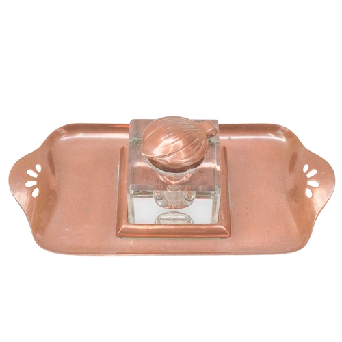 222 - An Art Nouveau copper inkstand. Glass inkwell with tulip shaped lid, the tray with cut-out decoratio... 