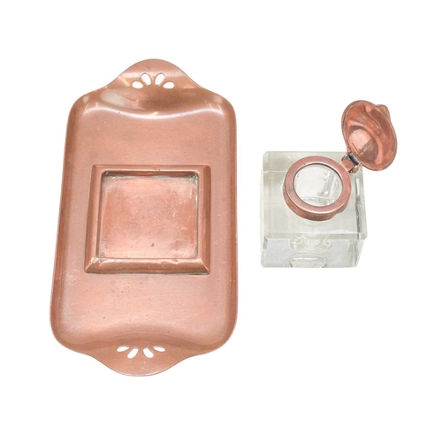 222 - An Art Nouveau copper inkstand. Glass inkwell with tulip shaped lid, the tray with cut-out decoratio... 