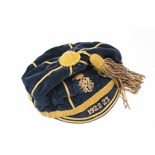 297 - A plush velvet rugby sports cap. Dated 1922-23, with bullion tassel, crest and trim, named G.R.Wilso... 