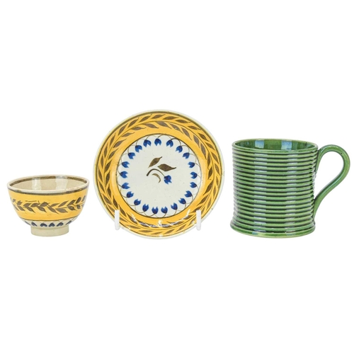 607 - A miniature Pratt type tea bowl and saucer. Circa 1820, centrally painted with a stylised flower, th... 