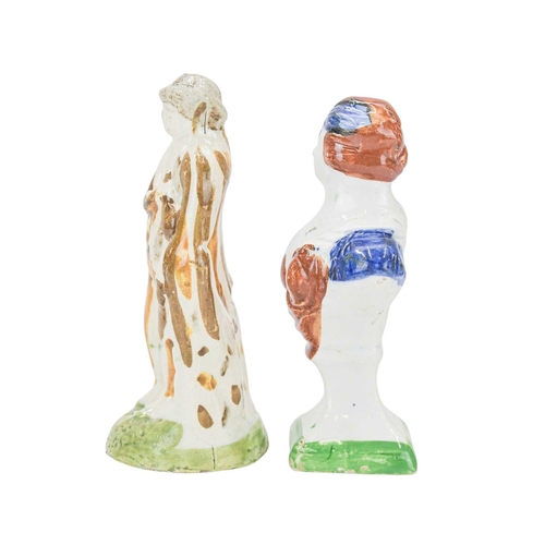 609 - A pearlware slip moulded figure of a man holding a bag. Circa 1820, painted in Pratt colours of ochr... 