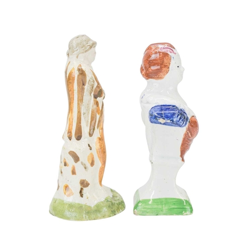 609 - A pearlware slip moulded figure of a man holding a bag. Circa 1820, painted in Pratt colours of ochr... 