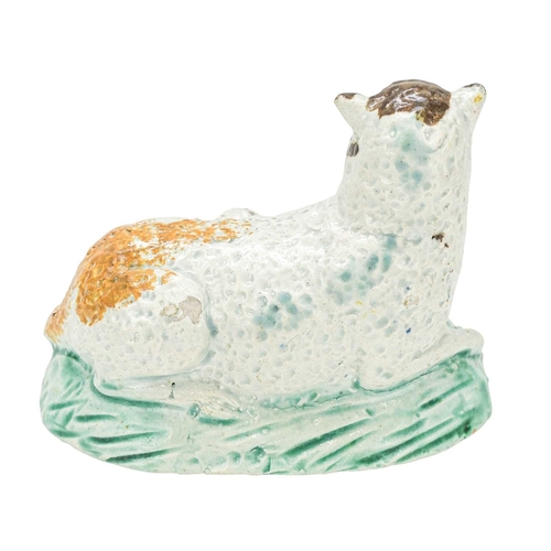 611 - A pearlware figure of a recumbent sheep and lamb. Circa 1800, painted in Pratt colours, brown, green... 