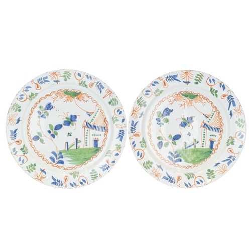 627 - A pair of English Delft polychrome chargers. Probably Bristol, circa 1760, painted in iron red, blue... 