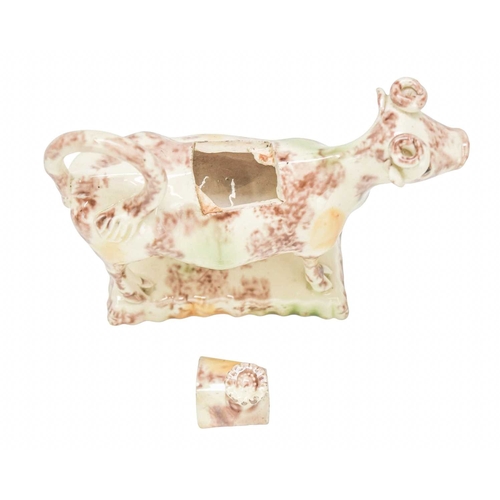 629 - A creamware Whieldon type cow creamer and cover. Circa 1760-1770, with sponged brown, green and ochr... 