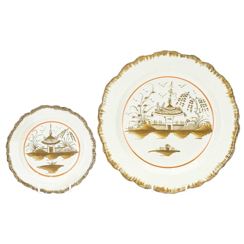 632 - A creamware pottery plate. Probably Yorkshire, circa 1800, with a brown painted feathered edge, pain... 
