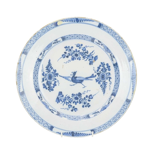 636 - An English Delft blue and white charger. Circa 1780, centrally painted with a pheasant type bird wit... 