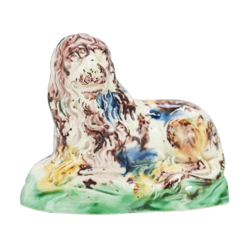 637 - A Whieldon type pottery figure of a lion. Circa 1780, modelled in a recumbent pose and splashed in b... 